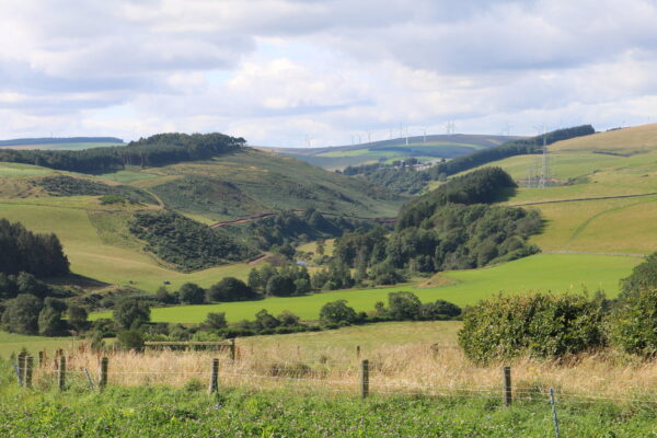 Stunning view of the Whiteadder river valley with wind farm in the distance.